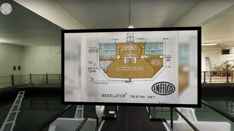 A screenshot of virtual reality video taken inside a water treatment facility. In addition to the facility itself, an illustration of a treatment unit is projected in front of the viewer.