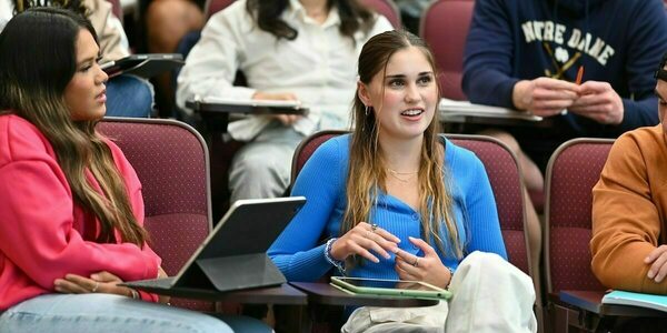 a student makes a comment in class while another student to her left listens