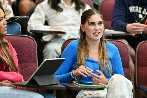 a student makes a comment in class while another student to her left listens