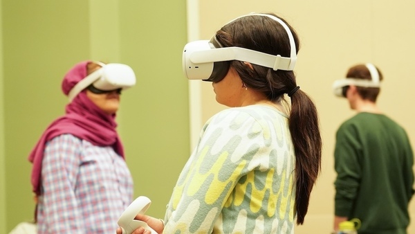 three architecture students in VR headsets go through the virtual HafenCity experience