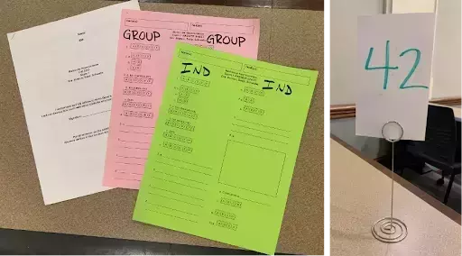 On the left, a white question booklet, pink answer sheet labeled GROUP, and a green answer sheet labeled IND (for individual). On the right in a separate photo, a white card displaying the number 42 in green, held by a metal stand atop a desk.