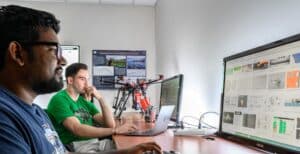 Students work at computers as part of the artificial intelligence drone response UAS research group