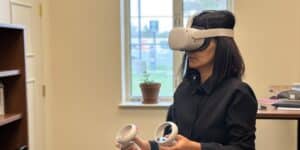 Ming Hu, an associate professor in Notre Dame’s School of Architecture, in a VR headset reviewing an initial build-out of the virtual reality HafenCity lessons.